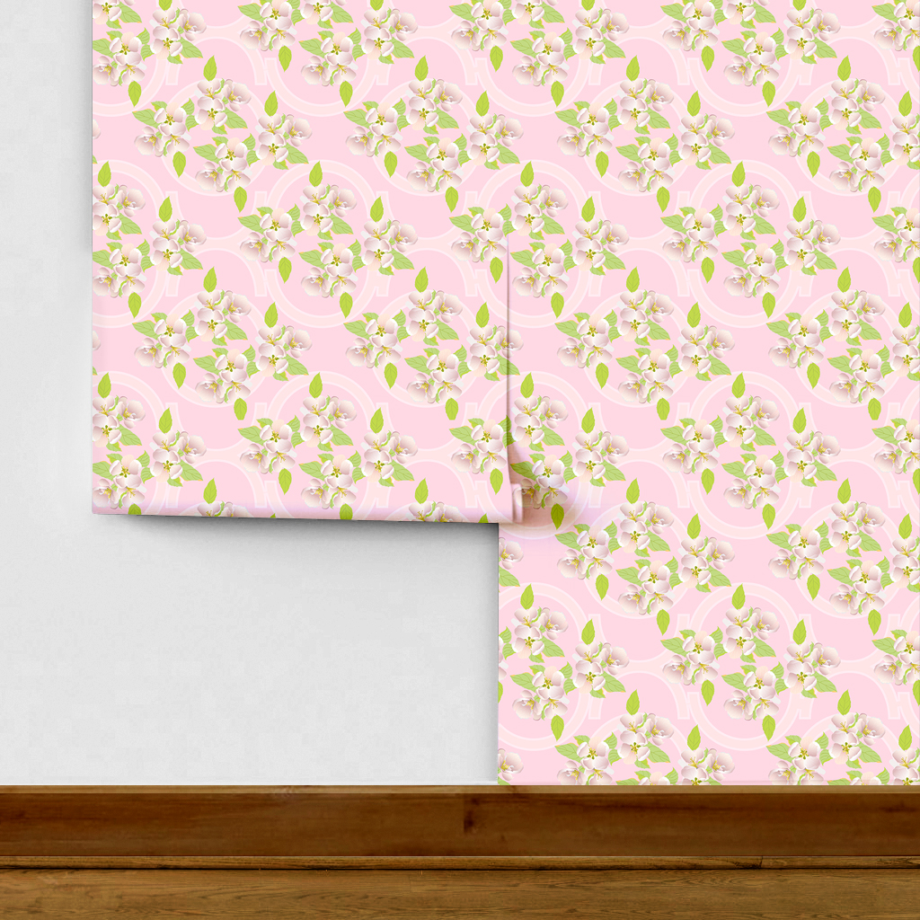 The artwork is a floral pattern showcasing delicate white and light pink blossoms with yellow stamens, complemented by vibrant green leaves. The flowers and leaves are distributed evenly across a soft pink background, which features subtle, pale geometric shapes that add depth without overpowering the organic floral elements.  The composition blends a gentle pastel color scheme with natural motifs, creating a light, fresh, and elegant aesthetic. 