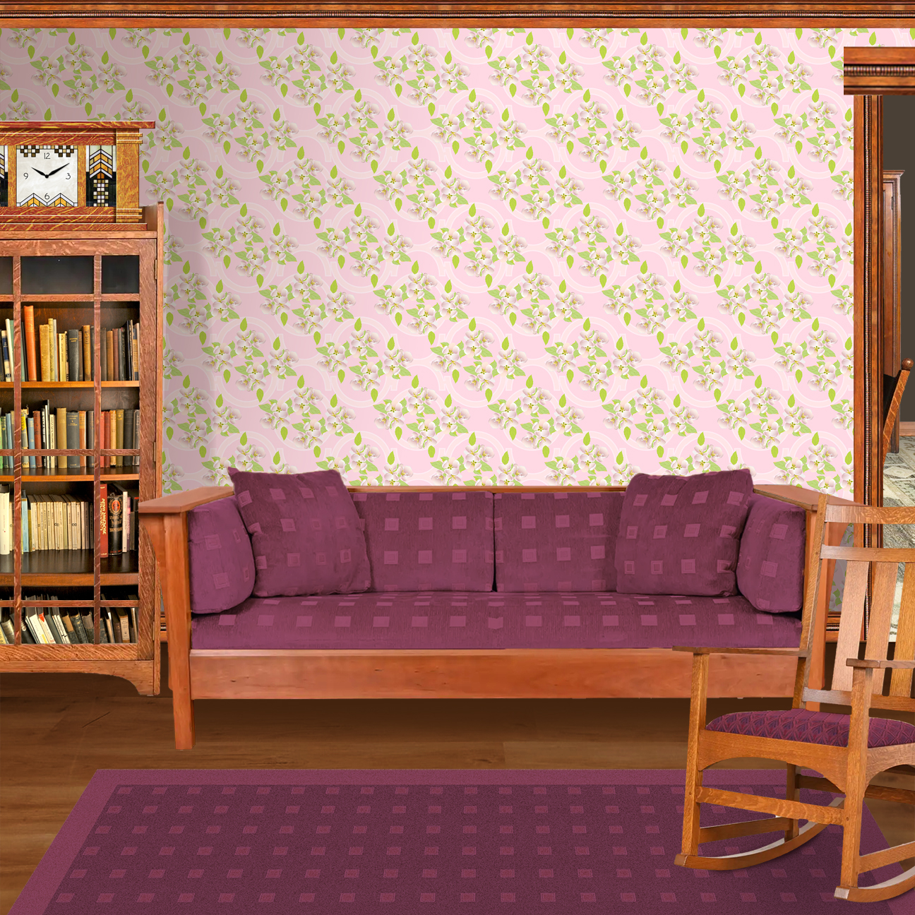 The artwork is a floral pattern showcasing delicate white and light pink blossoms with yellow stamens, complemented by vibrant green leaves. The flowers and leaves are distributed evenly across a soft pink background, which features subtle, pale geometric shapes that add depth without overpowering the organic floral elements.  The composition blends a gentle pastel color scheme with natural motifs, creating a light, fresh, and elegant aesthetic The wallpaper design is shown in a Mission style living room