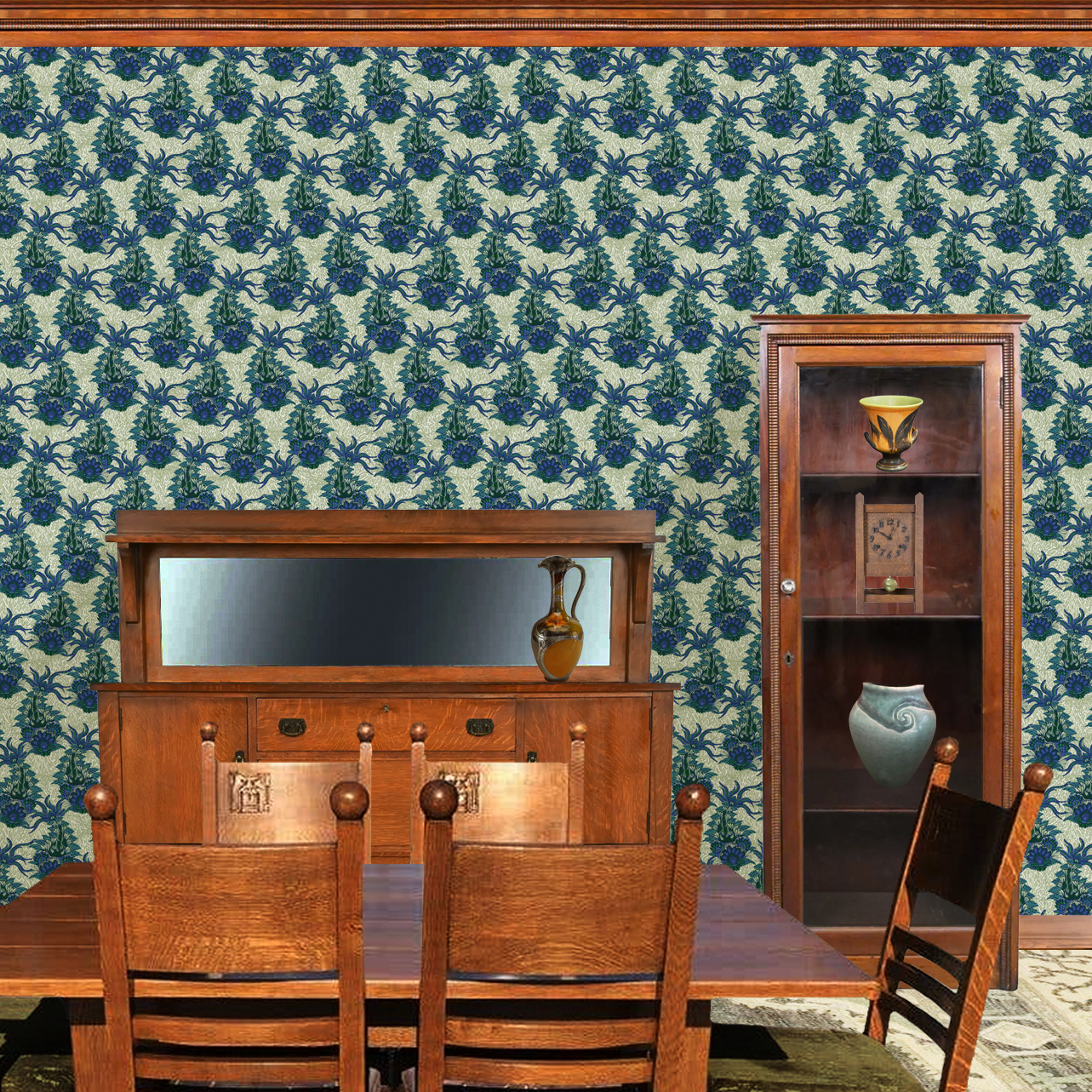 The artwork is a textile design featuring an intricate floral pattern. It showcases large, stylized flowers primarily in shades of blue and green. The flowers have detailed petals with layered, petal-like shapes creating a sense of depth and richness. Interwoven with the flowers are long, curved leaves and stems, adding dynamic movement to the composition. The background consists of a muted, light beige area patterned with subtle, organic shapes that resemble small leaves or plant forms, providing texture without overwhelming the main floral elements. The wallpaper design is shown in a Mission style dining room.