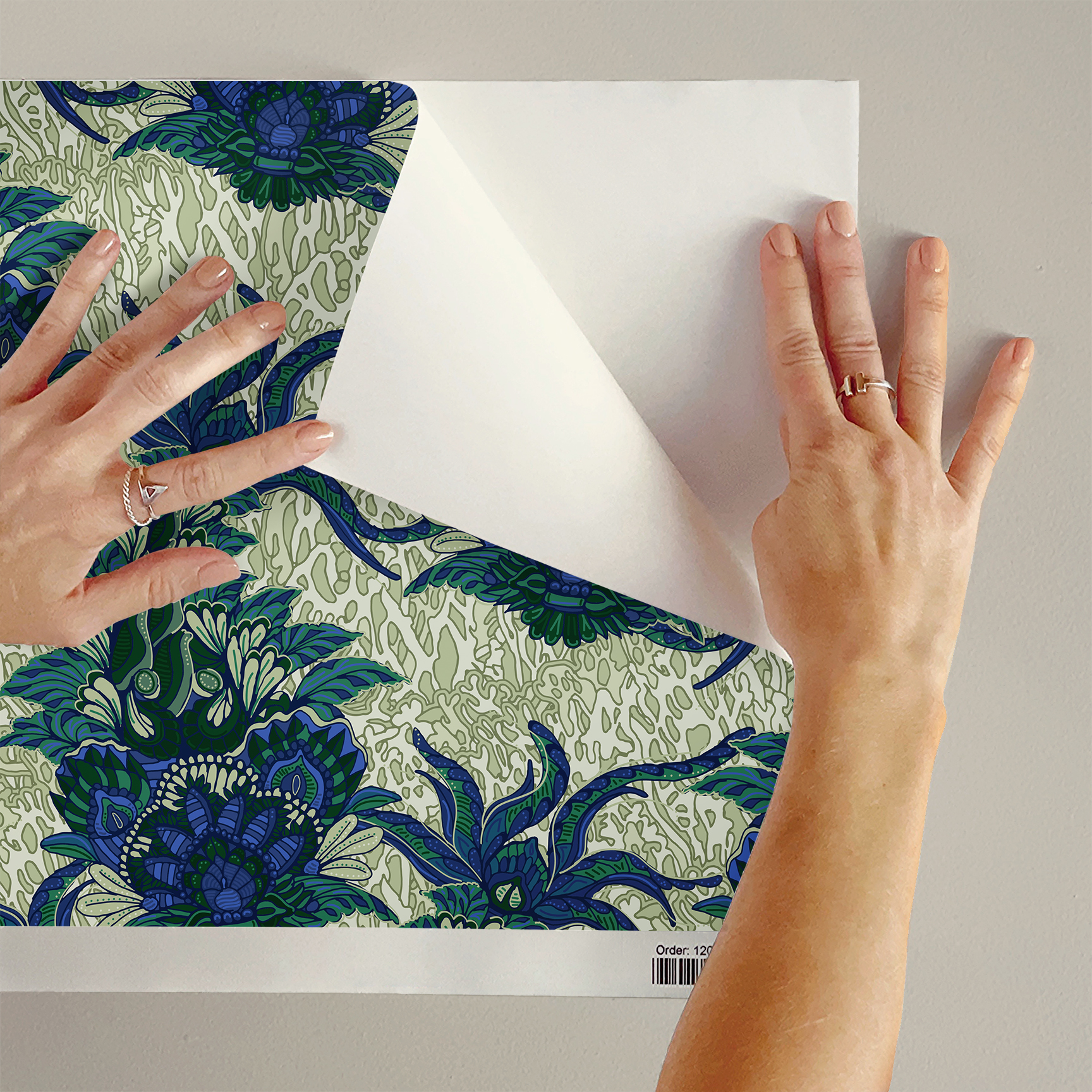 The artwork is a textile design featuring an intricate floral pattern. It showcases large, stylized flowers primarily in shades of blue and green. The flowers have detailed petals with layered, petal-like shapes creating a sense of depth and richness. Interwoven with the flowers are long, curved leaves and stems, adding dynamic movement to the composition. The background consists of a muted, light beige area patterned with subtle, organic shapes that resemble small leaves or plant forms, providing texture without overwhelming the main floral elements.