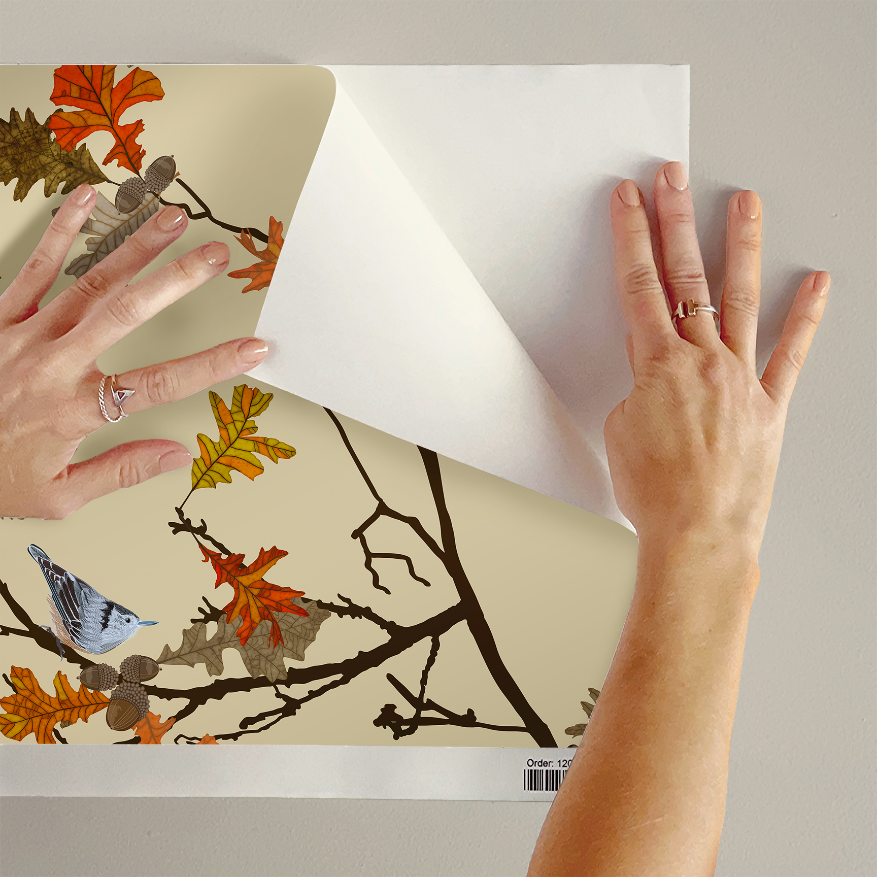 The artwork consists of delicate autumn branches adorned with detailed oak leaves in various shades of orange, yellow, brown, and tan. The branches intertwine gracefully against a solid beige background, creating an elegant and natural composition. Two small nuthatch birds with intricate black-and-white plumage are perched among the leaves, adding a subtle contrast and a lively element to the piece. Tree frogs are nestled in the joining twigs. The overall style is refined and decorative, highlighting the beauty of fall foliage and wildlife.
