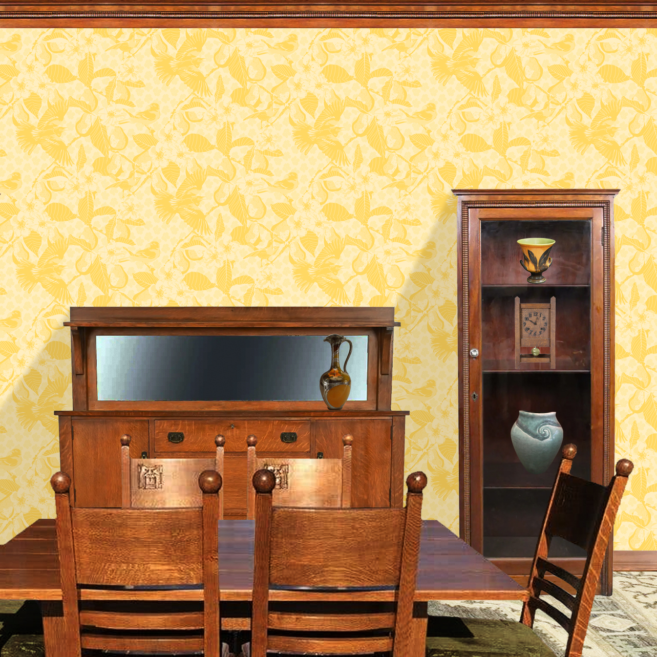 The artwork showcases a vibrant and detailed pattern featuring three orange and black birds set against a backdrop of yellow pears, green leaves, and white blossoms. The birds are depicted in different poses: one perched on a branch, one in mid-flight with wings spread, and another near a pear. The rich colors and intricate details of the feathers, fruits, and flowers create a lively and harmonious composition. The overall style combines naturalistic elements with a decorative, repeating design, highlighting the beauty of nature with emphasis on bold contrasts and vivid hues. The wallpaper design is shown in a Mission style dining room.