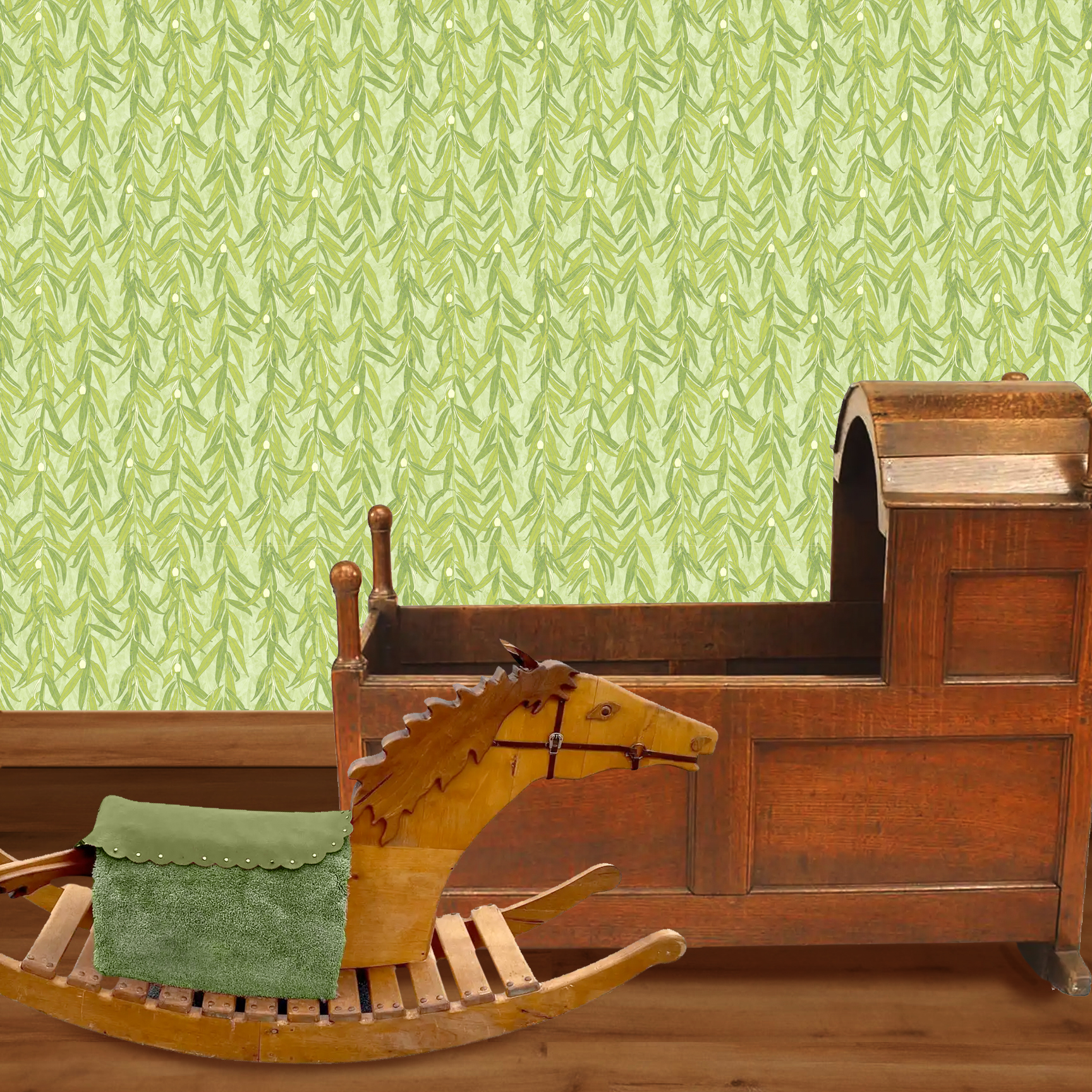 The artwork is a repeating pattern of olive branches with slender green leaves and small, light yellow-green olives set against a pale textured background. The branches hang vertically, creating a cascading effect. The color palette is composed of various shades of green and soft yellow tones, giving the piece a natural, calming, and organic feel.  The wallpaper design is shown in a Mission style nursery.