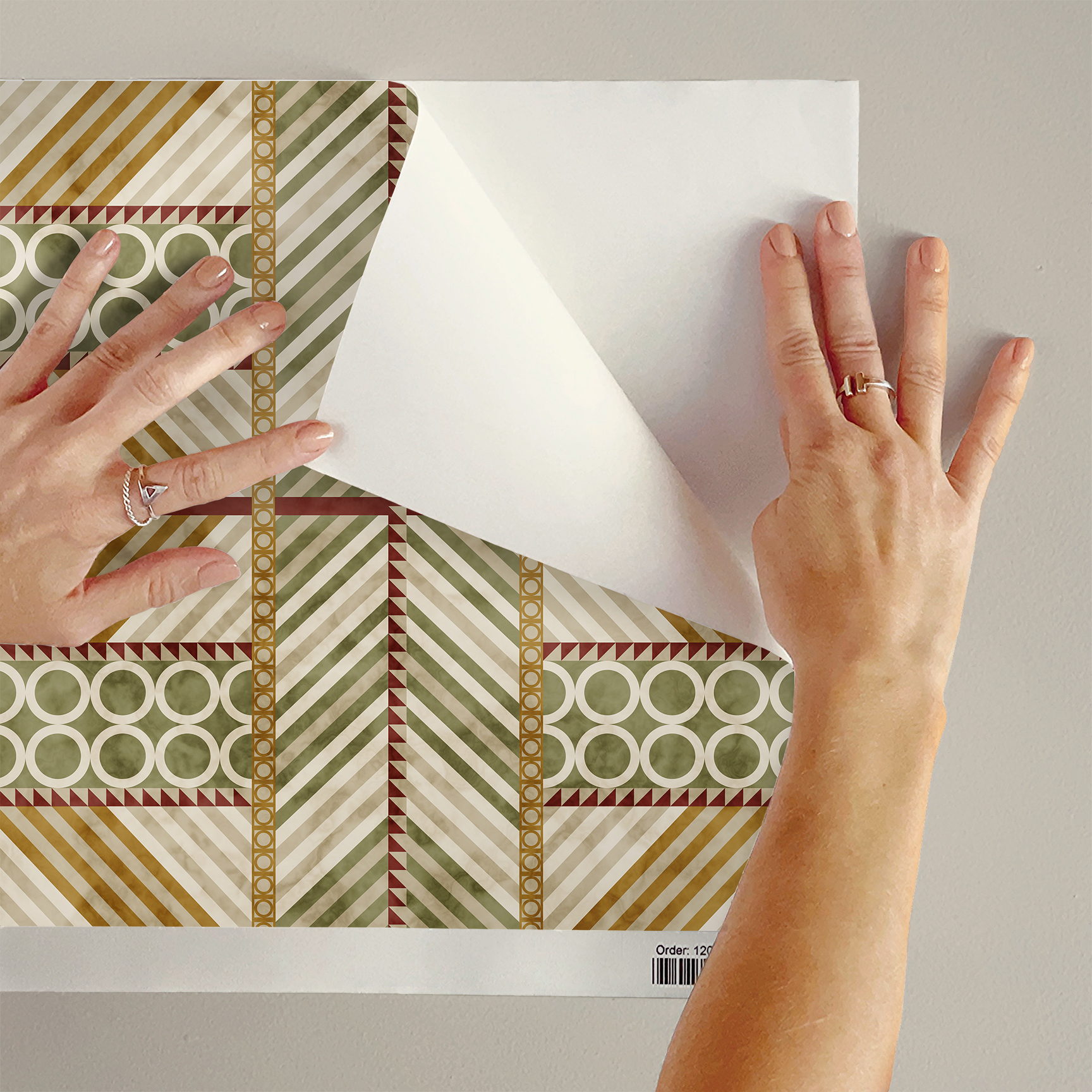 The artwork is a geometric composition featuring a symmetrical design dominated by diagonal stripes in shades of tan, rust and green. The central area is divided into four quadrants by two intersecting dark purple bands. Each quadrant contains diagonal stripes that create a chevron pattern, alternating between lavender and green hues. Vertical bands with circular motifs in black frame the central quadrants on the left and right sides. The outer edges are decorated with semicircular and triangular shapes, adding contrast with bold green and white patterns.The interplay of pastel colors and geometric forms gives the artwork a structured yet visually engaging appearance.