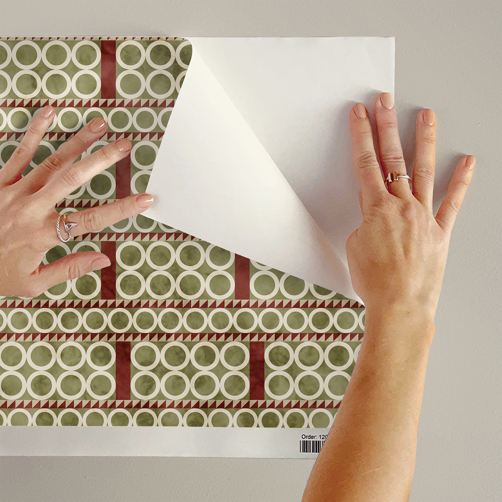 The artwork is a geometric composition featuring a symmetrical design dominated by diagonal stripes in shades of tan, rust and green. The central area is divided into four quadrants by two intersecting dark purple bands. Each quadrant contains diagonal stripes that create a chevron pattern, alternating between lavender and green hues. Vertical bands with circular motifs in black frame the central quadrants on the left and right sides. The outer edges are decorated with semicircular and triangular shapes, adding contrast with bold green and white patterns.The interplay of pastel colors and geometric forms gives the artwork a structured yet visually engaging appearance.